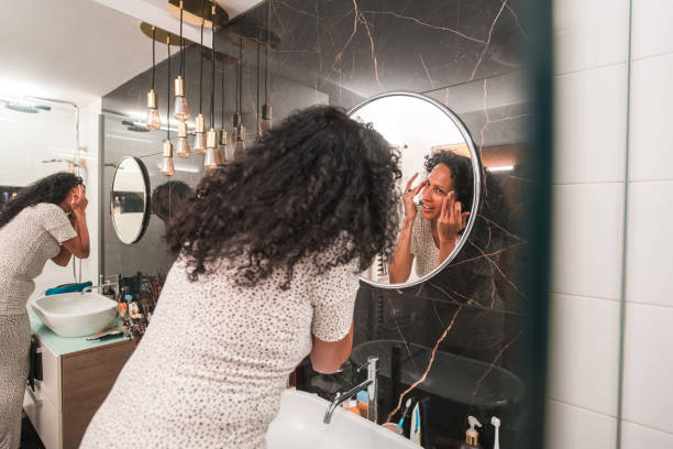 istock Hispanic Female Applying A Face Cream At Home 1478291213