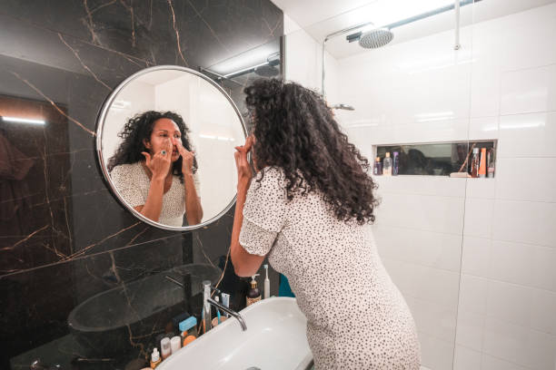 istock Hispanic Female Applying A Face Cream At Home 1478291234