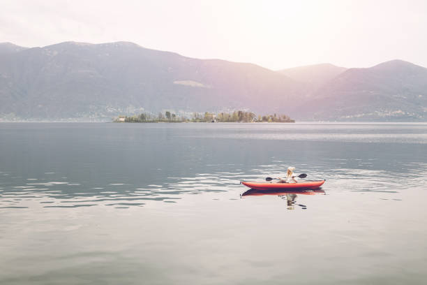 istock Woman canoeing on calm lake 1478296199