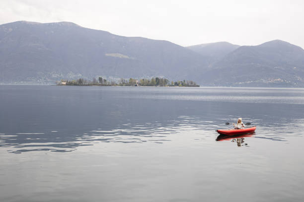 istock Woman canoeing on calm lake 1478296326