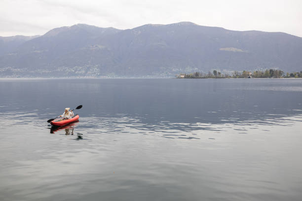 istock Woman canoeing on calm lake 1478296799