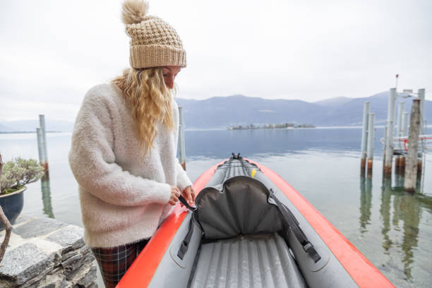 istock Woman preparing canoe, adjusting the seat post 1478297103