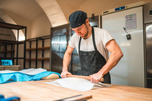 istock Caucasian Artisan Baker Rolling Butter Wrapped In A Baking Paper 1478300493