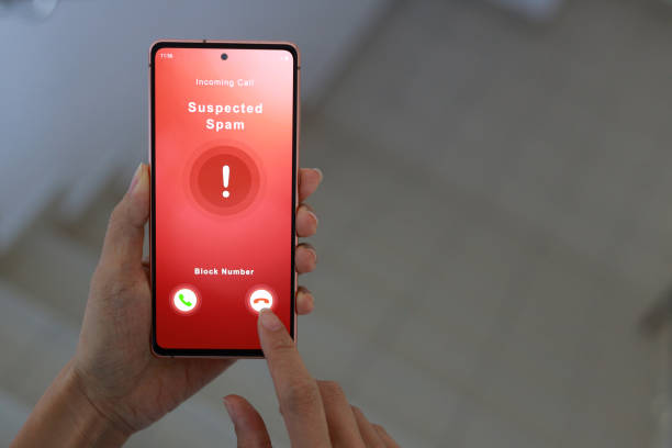 istock A woman receiving suspected spam call on smartphone from an unknown caller while walking down a staircase in an office. 1478303869