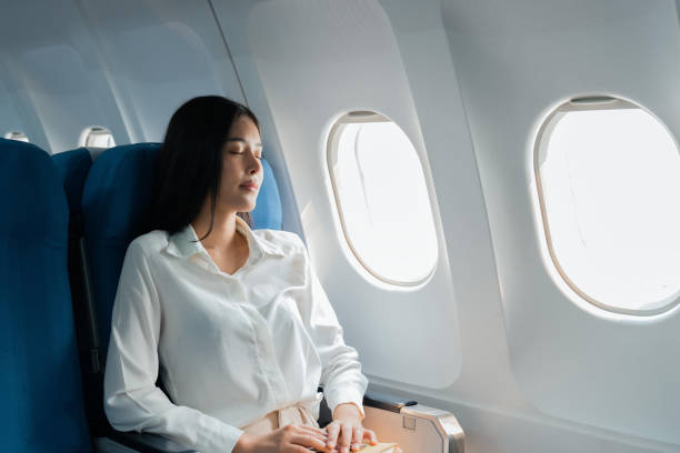 A female passenger traveling by plane sleeping on cushion airplane