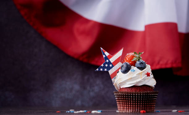 istock Sweet cupcakes with blueberries and strawberry over USA flag background 1478304607