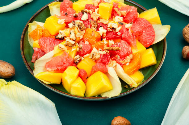 istock Fruit salad of citrus, chicory and nuts. 1478305483