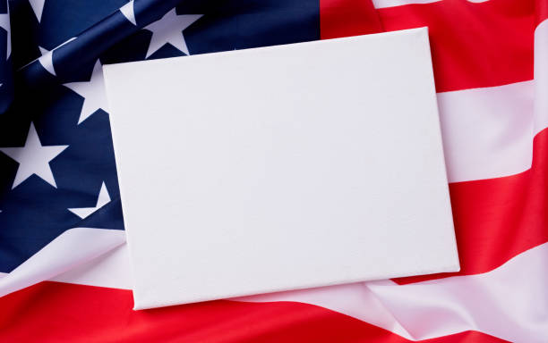 istock Blank white canvas frame for mockup design on American national flag background 1478305707