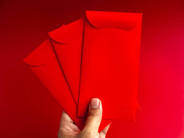 istock Three red envelope holding by hand isolated on red background. 3 Hongbao packets for lucky money gift in Chinese lunar, new year on January month, wedding red packet. 1478307335