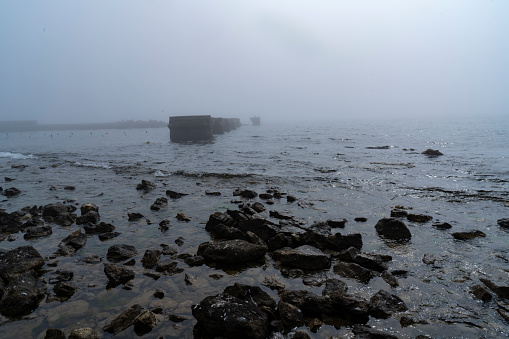Deserted jetty, pier in foggy weather, horizontal shot