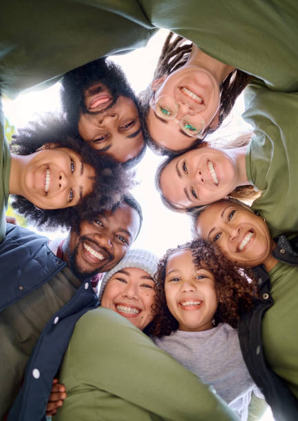 Teamwork, community and face of people in circle for support, motivation and working together outdoors. Collaboration, diversity and portrait of group smile for for volunteer, charity and social work