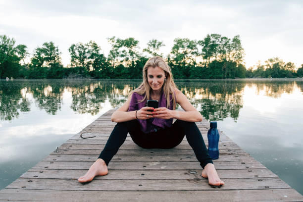 istock cheerful athletic woman relaxing after a workout 1478309902