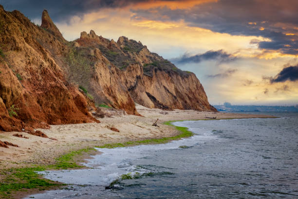 Scenic sea coast at the sunset. Scenic sea coast at the sunset. Picturesque sand cliffs and dramatic sunset sky at the Black Sea, Ukraine odessa beach stock pictures, royalty-free photos & images
