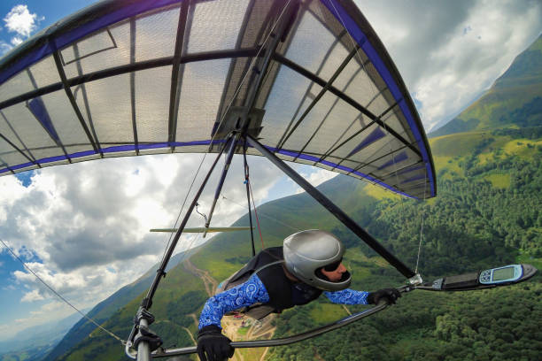 istock Girl hang glider pilot soars in the mountains 1478310150