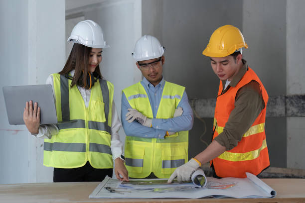 istock Team of engineer and architects working, meeting, discussing, designing, planning, measuring layout of building blueprints at construction site, Construction concept 1478314192