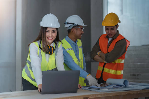 istock Young woman construction engineer work with laptop at a construction site 1478314228