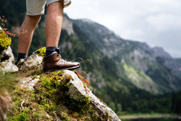 istock Adventure man hiking wilderness mountain with backpack 1478315828