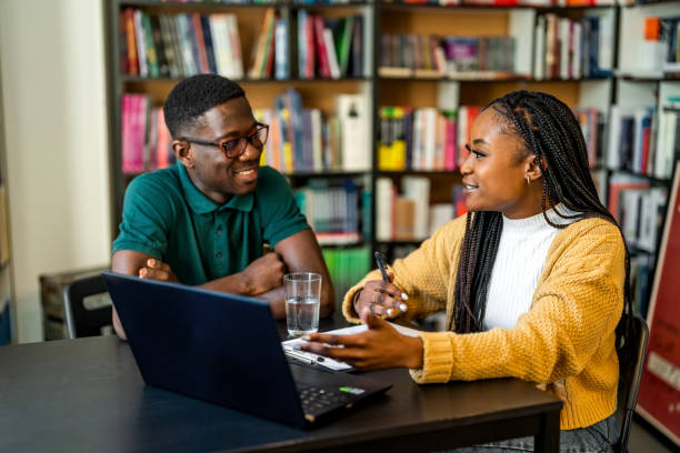 istock Smiling African-American Students Talking In The Library 1478316419