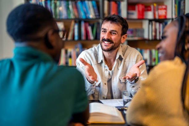 istock Male consultant explaining a document to a young couple 1478316561