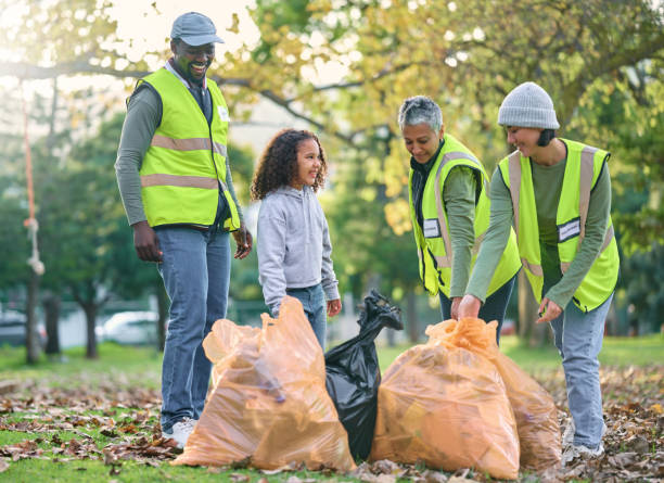 istock Child with volunteer group for cleaning park with garbage bag for a clean environment. Men, women and child team helping and learning eco friendly lifestyle, community service and recycling in nature 1478316675
