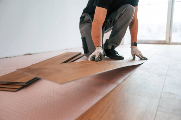 istock Fitting the planks. Man is installing new laminated wooden floor 1478316919