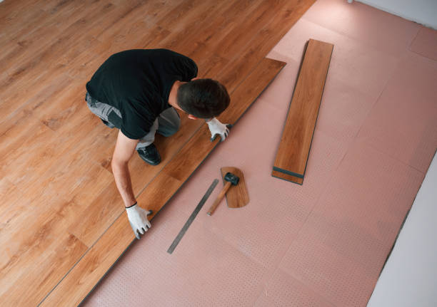 istock Top view. Man is installing new laminated wooden floor 1478317002