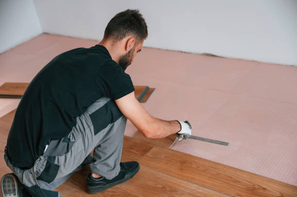 istock Using the rubber hammer. Man is installing new laminated wooden floor 1478317009
