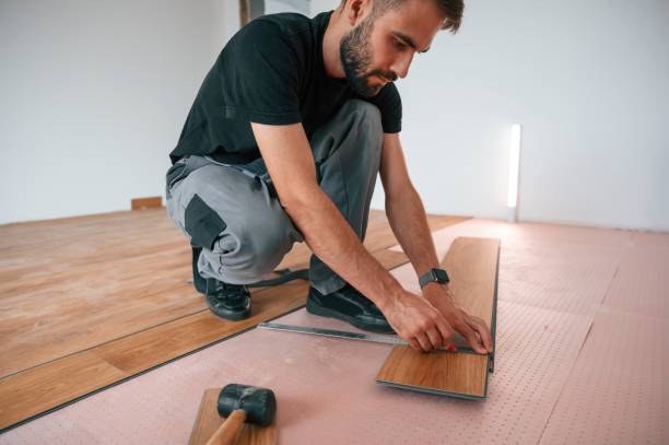 istock Hand work. Man is installing new laminated wooden floor 1478317024