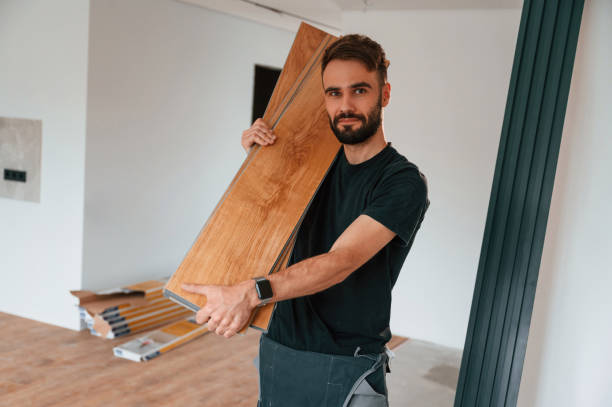 istock Plank is in the hands. Man is installing new laminated wooden floor 1478317629