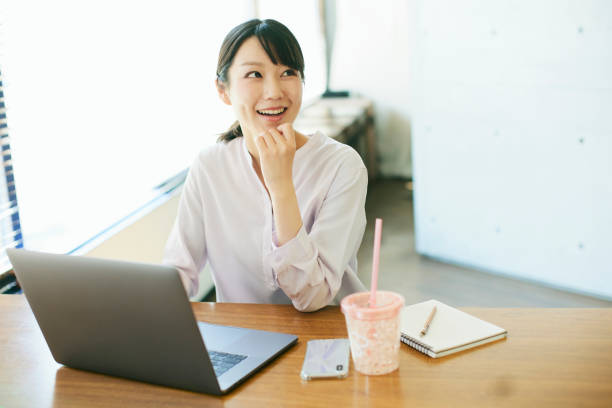 istock Young Asian woman working in an office by the window 1478318344
