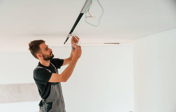 istock Installing lighting equipment on the ceiling. Man is working indoors at domestic room 1478318614