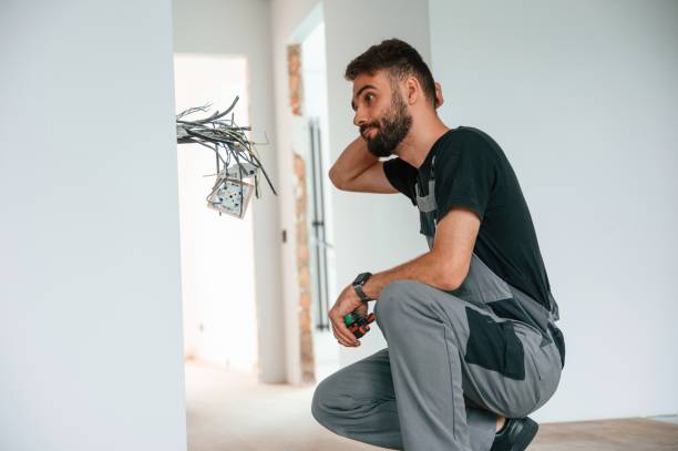 Electrician is working with wires indoors in the room stock photo