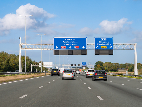 UTRECHT, NETHERLANDS - OCT 15, 2021: Traffic and route information on overhead gantry, motorway A27 between Utrecht and Hilversum