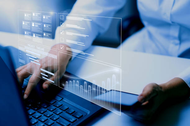 istock Business data management system concept background. Business person working on computer updating tasks and milestones progress, complete the online survey form. 1478321598