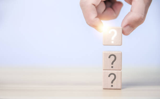 istock hand holding wooden block showing white question mark icon 1478323105
