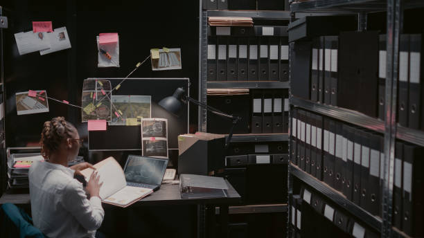 istock Law enforcement agent reading archive records at desk 1478324730