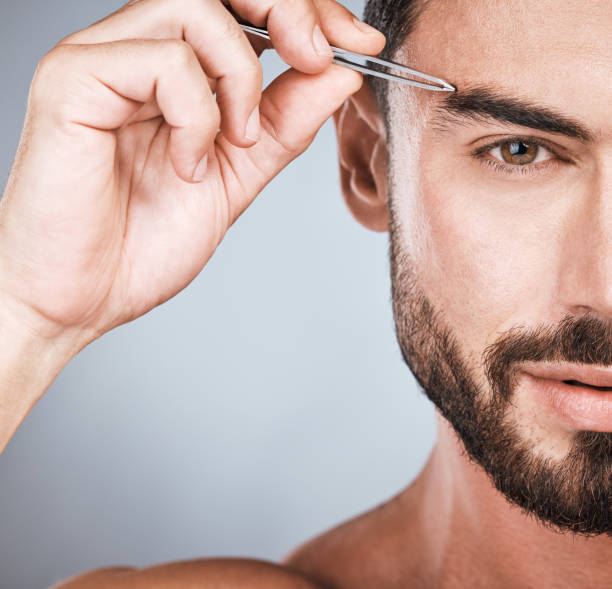 istock Portrait, man and tweezers for eyebrows, cosmetics and morning routine with guy on grey studio background. Face care, male and gentleman with skincare, beauty and hair removal for grooming and facial 1478325533