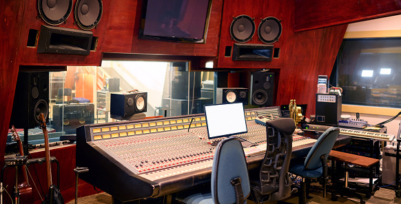 Music, studio and technology with recording equipment in an empty room for the entertainment industry. Interior, creative and audio with musical electronics to produce, record or control sound