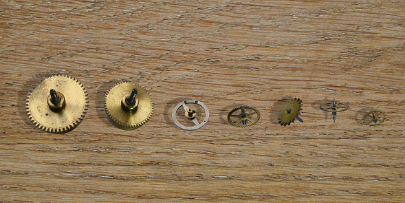 Still life with gear wheels on the wooden desk