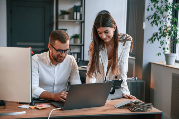 istock With laptop. Two employees are working together in the modern office 1478328666