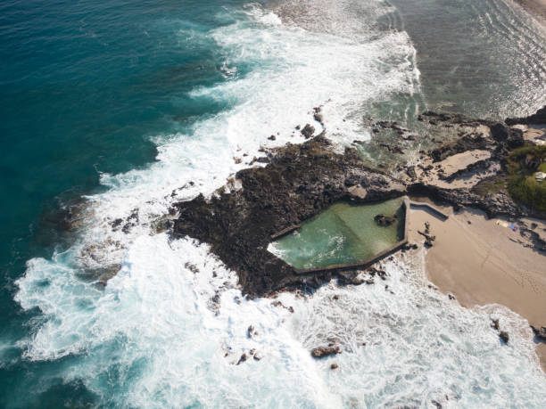 drone point of view of an natural swimming pool at reunion island.