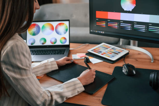 istock Drawing by using graphic tablet. Woman is working in the modern office with computer 1478334828