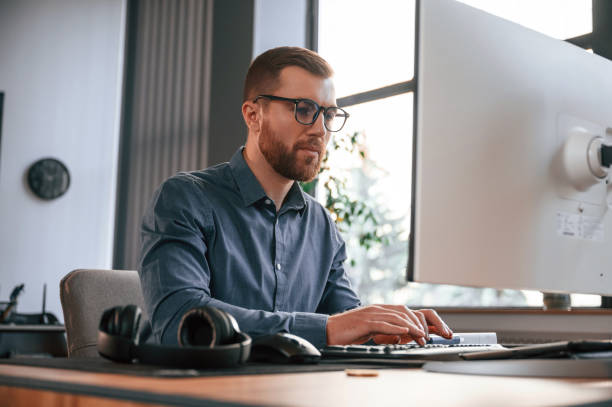 istock Typing on the keyboard. Man in formal clothes is working in the modern office. Using computer 1478334984