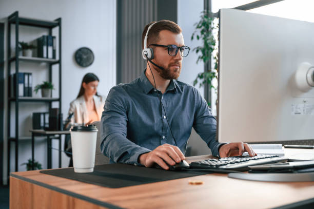 istock Man is using computer. Two employees are working together in the modern office 1478334988