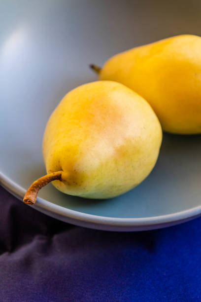 yellow apples and pears close up in a bowl fall vibe