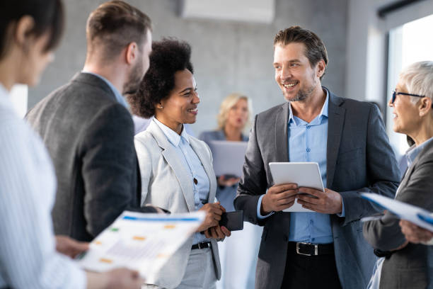 istock Group of happy business colleagues communicating in a hallway. 1478335598