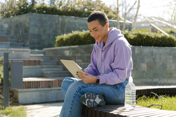 istock Young woman using digital tablet on the street 1478342033