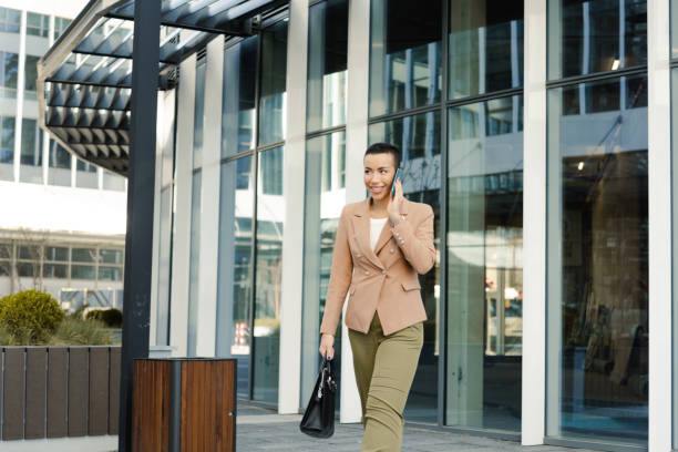 istock Young woman using smartphone on the street 1478342049