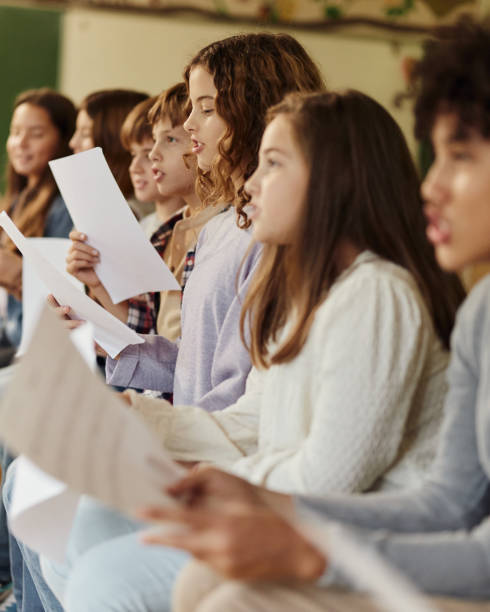 istock School kids practicing with sheet music on a class at school. 1478342058