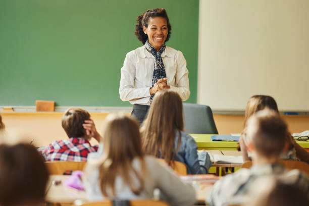 istock Happy black teacher giving a lecture at elementary school. 1478342109